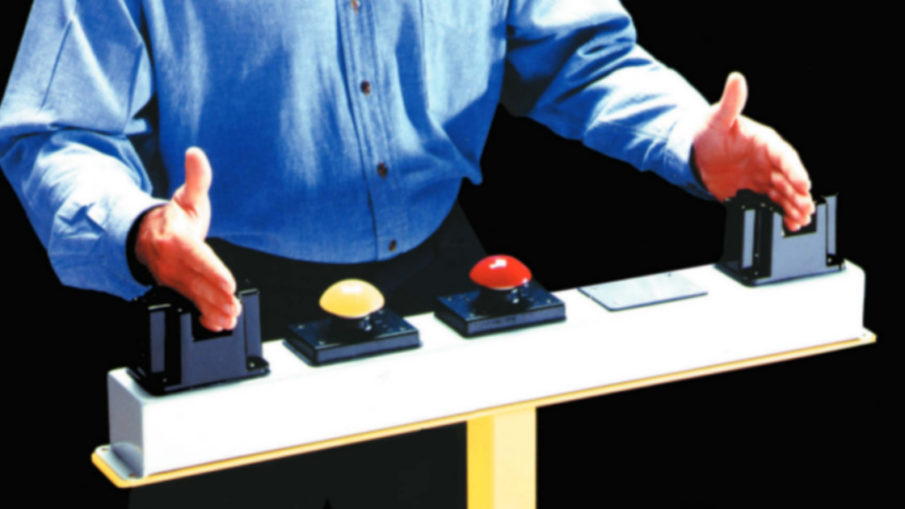 Operator using an ergonomic palm button in an industrial setting, demonstrating safe two-hand control for machinery operation.