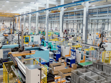 Machine shop floor with safety mats placed around heavy machinery, enhancing worker safety and preventing accidents in a high-risk industrial environment.