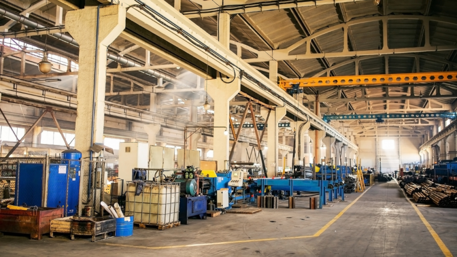 Industrial plant floor featuring perimeter guarding around robotic systems, ensuring worker safety and controlled access to hazardous areas.