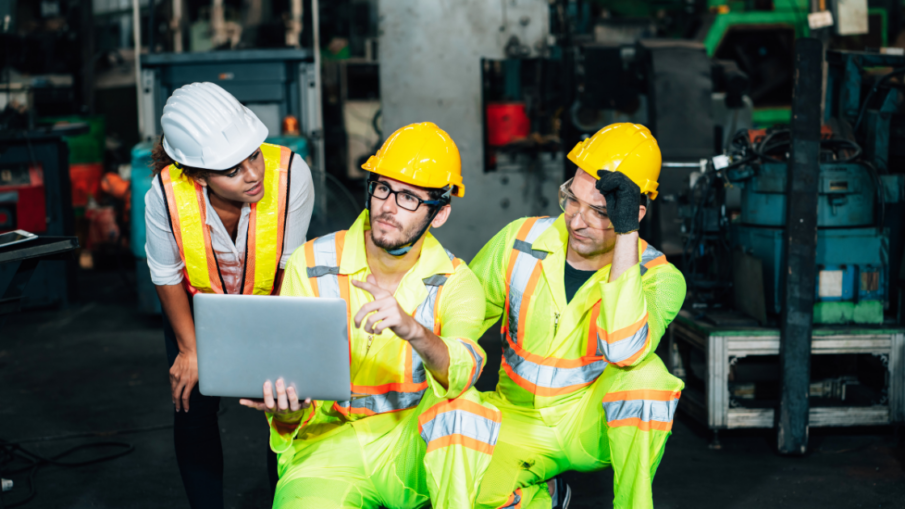 Safety workers strategizing in an industrial plant, ensuring proper implementation of safety controls to protect workers and enhance machine safety.