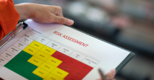 Close-up of a checklist labeled 'Risk Assessment,' emphasizing the importance of identifying hazards and planning for machine safety.