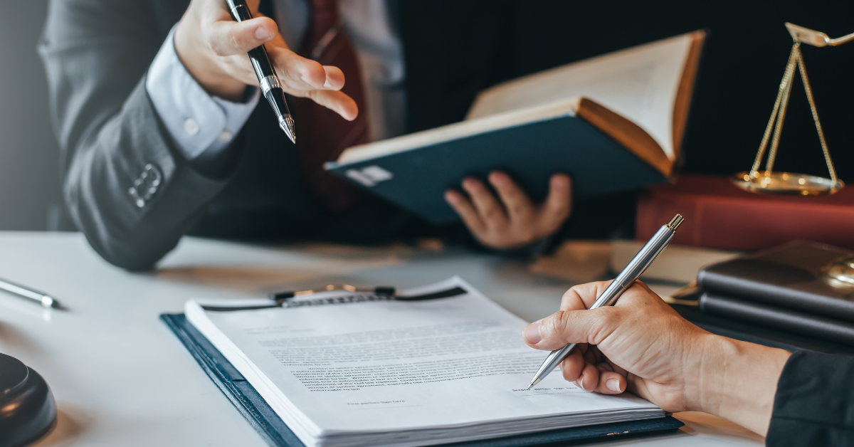 Lawyer consulting with a client about workplace safety compliance, discussing legal consequences and potential penalties for failing to meet OSHA regulations.